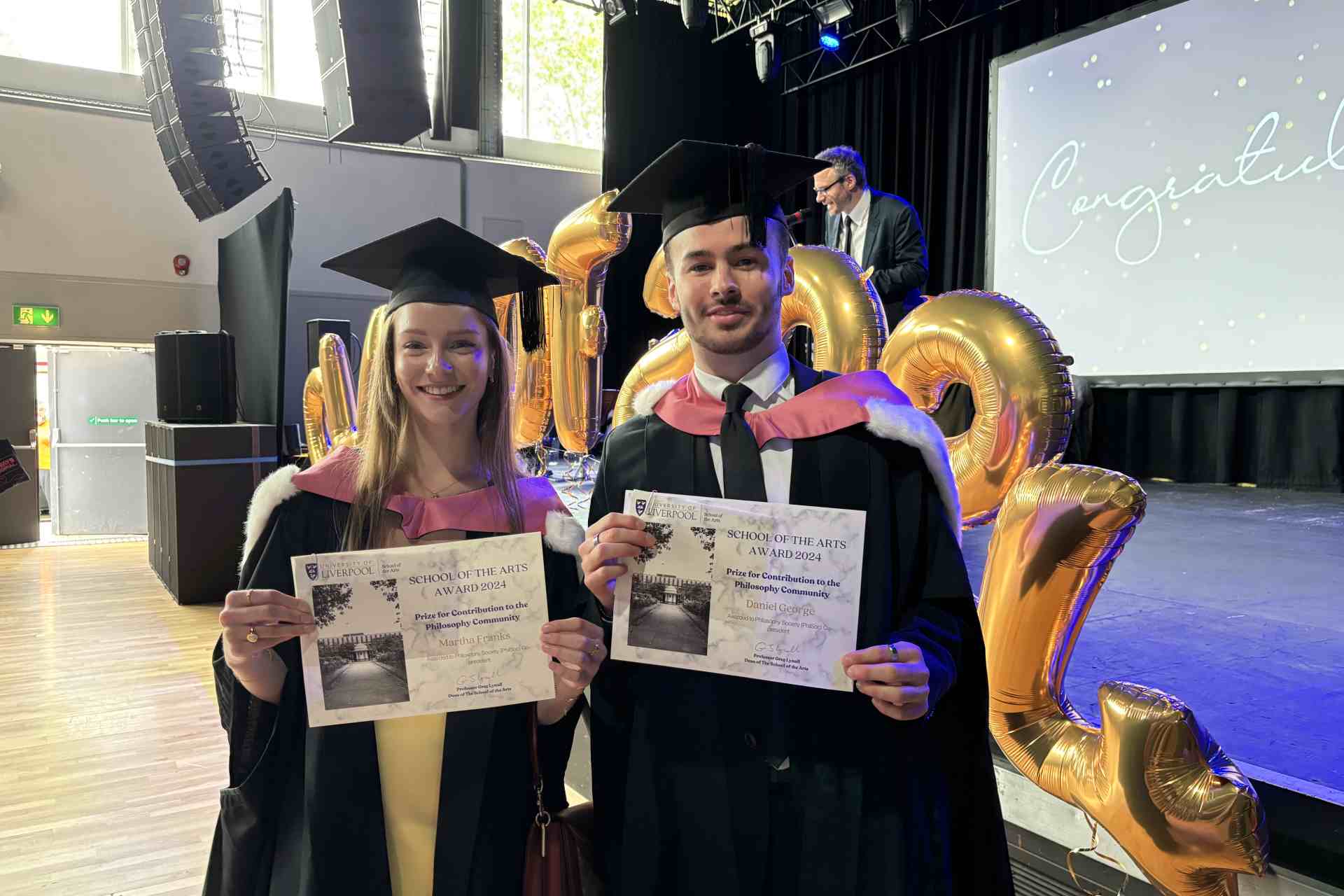 Philosophy graduates holding certificates