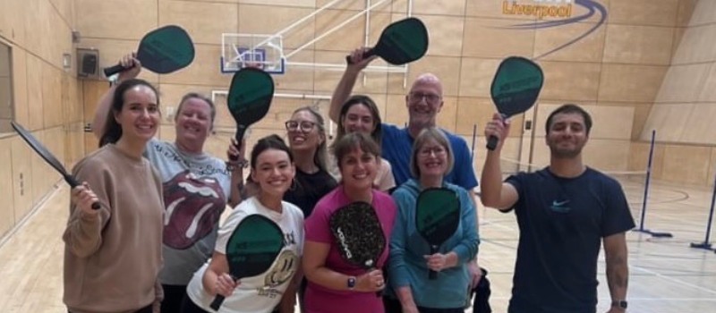 Members of staff playing pickleball