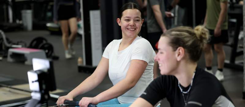 People rowing in gym