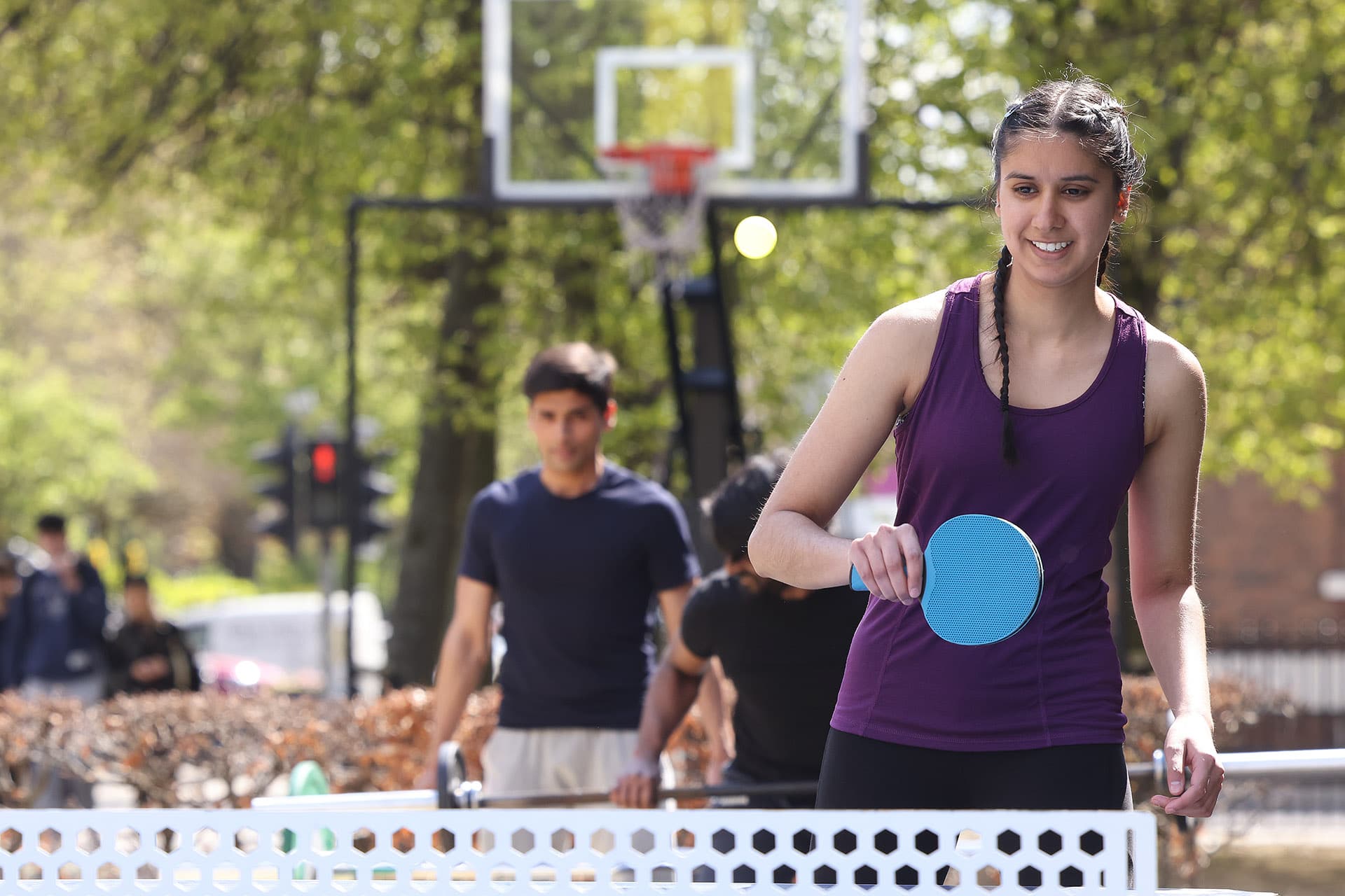 Woman playing table tennis outside