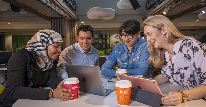 Postgraduate students studying on campus