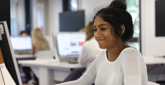 A student looking at a computer.