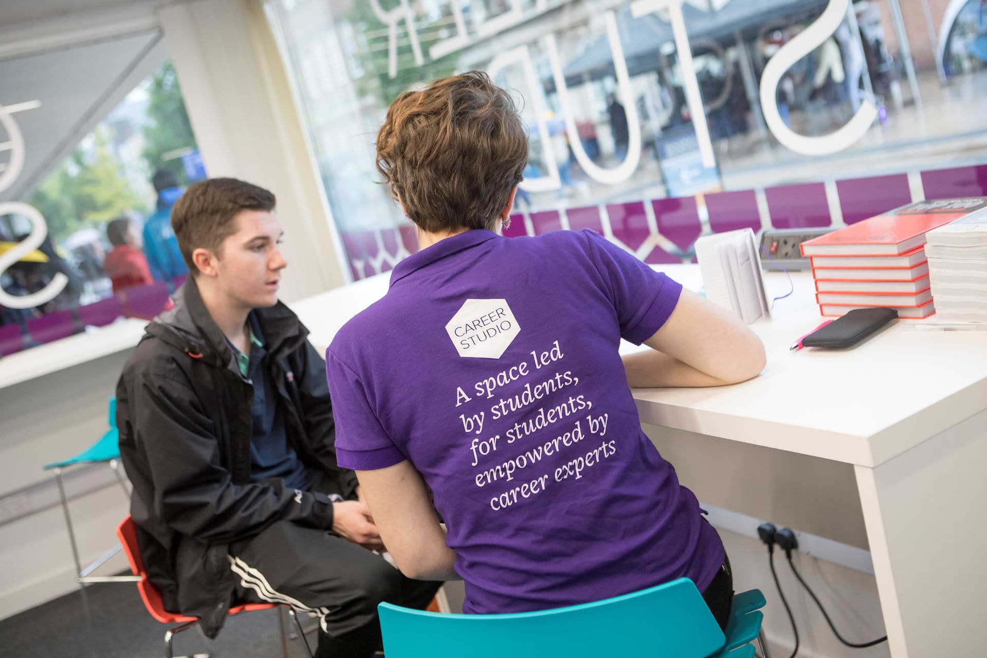 Student talking to careers coach in careers studio