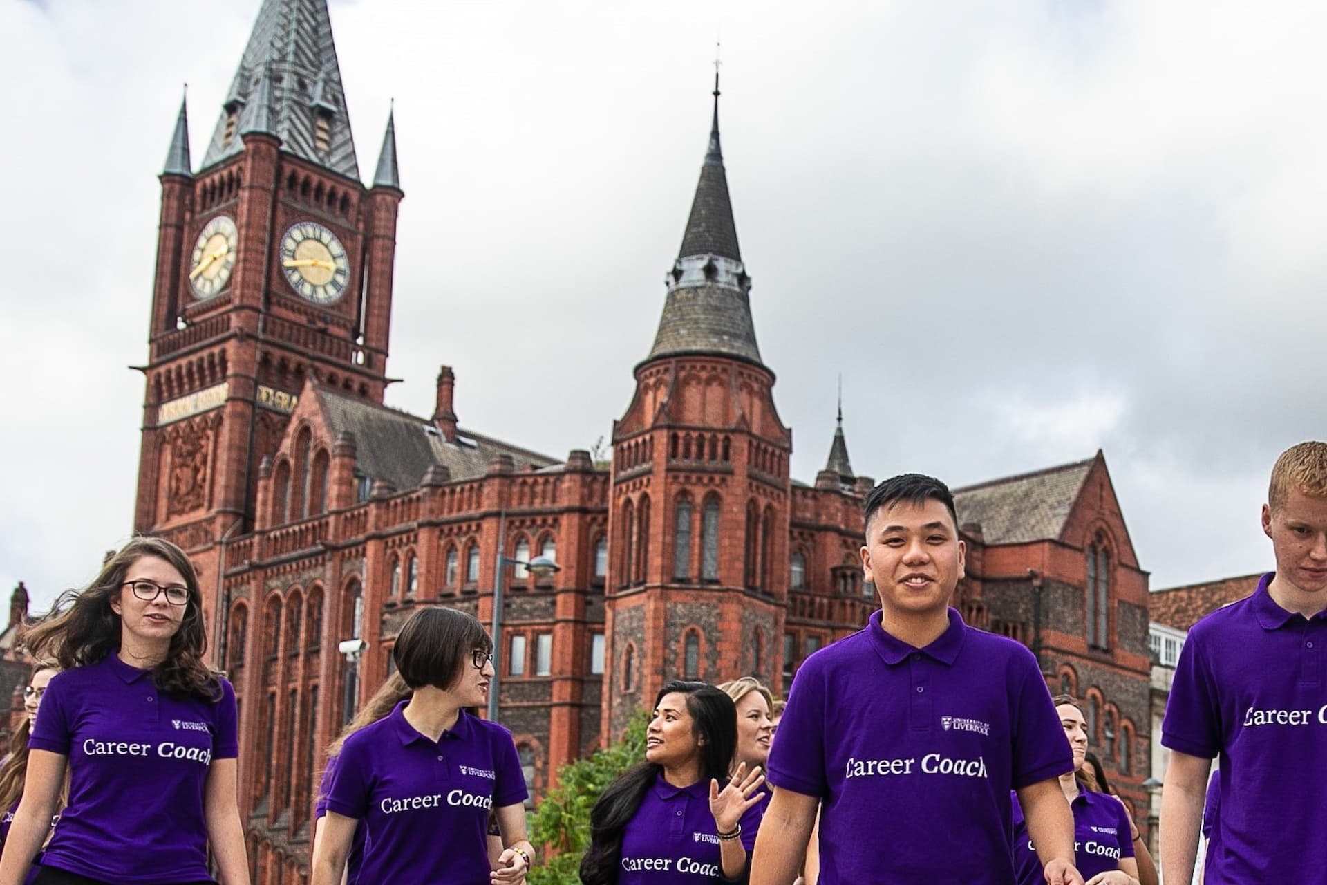 Careers Coaches walking on campus in front of redbrick building